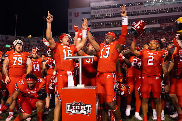 Aug 31, 2023; Salt Lake City, Utah, USA; Utah Utes quarterback Bryson Barnes (16) and quarterback Nate Johnson (13) celebrate their win and combined effort against the Florida Gators at Rice-Eccles Stadium. Mandatory Credit: Jeff Swinger-USA TODAY Sports